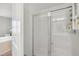 Bathroom showing a shower with a glass door, white tile, and a small shelf for storage at 202 Kirkland St, Goose Creek, SC 29445