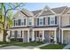 Charming townhome featuring neutral siding, black shutters, and covered porch at 202 Kirkland St, Goose Creek, SC 29445
