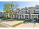 Street view of neutral townhomes with a manicured lawn and tree at 202 Kirkland St, Goose Creek, SC 29445