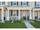 Inviting porch with rocking chairs, manicured landscaping, and decorative door wreath enhances curb appeal at 202 Kirkland St, Goose Creek, SC 29445