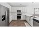 Well-equipped kitchen features white cabinets, stainless steel appliances, and ample counter space at 202 Kirkland St, Goose Creek, SC 29445