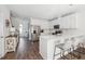 Modern kitchen with white cabinets, stainless steel appliances, and a stylish island with bar seating at 202 Kirkland St, Goose Creek, SC 29445