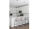 Modern kitchen features white cabinets, stainless steel appliances, and an island with bar stools at 202 Kirkland St, Goose Creek, SC 29445