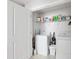 A well-organized laundry room with a washer, dryer, and storage shelf at 202 Kirkland St, Goose Creek, SC 29445