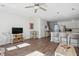 Bright and airy living room featuring hardwood floors, ceiling fan, and open access to kitchen and staircase at 202 Kirkland St, Goose Creek, SC 29445