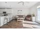 Comfortable living room showcasing hardwood floors, a modern kitchen, and bright natural light at 202 Kirkland St, Goose Creek, SC 29445