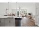Open living space boasts stainless steel appliances, hardwood floors, modern lighting, and ample natural light at 202 Kirkland St, Goose Creek, SC 29445