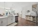 Sunlit open living area featuring hardwood floors, stairs to upper level, and stainless steel appliances at 202 Kirkland St, Goose Creek, SC 29445
