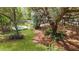 Aerial shot of lush backyard with swimming pool, patio, and towering trees surrounding the property at 2111 Nicholas David Path, Johns Island, SC 29455