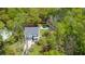 Aerial view of home with backyard pool and lush landscaping, surrounded by dense, mature trees at 2111 Nicholas David Path, Johns Island, SC 29455