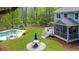 Spacious backyard with a pool, patio, lush lawn, and a charming home with a screened porch at 2111 Nicholas David Path, Johns Island, SC 29455