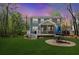 The backyard features a patio with a table, umbrella, green grass, and a covered porch at 2111 Nicholas David Path, Johns Island, SC 29455