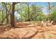 Spacious backyard featuring a fire pit, Adirondack chairs, and mature trees at 2111 Nicholas David Path, Johns Island, SC 29455