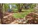 An inviting backyard featuring a circular seating area with a fire pit and wooded views at 2111 Nicholas David Path, Johns Island, SC 29455
