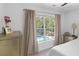 Bedroom view showcasing a lush backyard with a refreshing pool, seen through a large window at 2111 Nicholas David Path, Johns Island, SC 29455