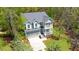 A charming home featuring a gray roof, blue siding, and multiple balconies, nestled among mature trees at 2111 Nicholas David Path, Johns Island, SC 29455