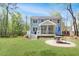 Beautiful backyard with a well-manicured lawn, patio area, and a charming home exterior at 2111 Nicholas David Path, Johns Island, SC 29455