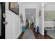 Bright foyer with hardwood floors, gray patterned rug, and decorative molding and decor at 2111 Nicholas David Path, Johns Island, SC 29455