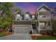 Charming home with a two-car garage, double porches, manicured lawn, and lush, mature landscaping at 2111 Nicholas David Path, Johns Island, SC 29455