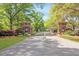 The gated entrance is adorned with brick pillars, complemented by verdant landscaping and mature trees at 2111 Nicholas David Path, Johns Island, SC 29455