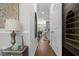 Long hallway with hardwood floors and a built-in wine fridge at 2111 Nicholas David Path, Johns Island, SC 29455