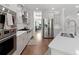 Modern kitchen features stainless steel appliances, white cabinets, and beautiful hardwood floors at 2111 Nicholas David Path, Johns Island, SC 29455