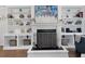 Bright and airy living room featuring custom built-in shelving around the fireplace at 2111 Nicholas David Path, Johns Island, SC 29455