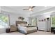 Large main bedroom with tray ceiling, and ample natural light from surrounding windows at 2111 Nicholas David Path, Johns Island, SC 29455