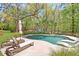 Beautiful backyard pool with in-pool loungers, deck chairs, and mature trees in a private setting at 2111 Nicholas David Path, Johns Island, SC 29455
