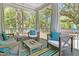Relaxing screened porch with comfortable seating and a view of the green, wooded backyard at 2111 Nicholas David Path, Johns Island, SC 29455