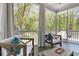 Relaxing screened-in porch with comfortable seating and a beautiful view of the lush outdoor landscape at 2111 Nicholas David Path, Johns Island, SC 29455
