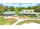 Aerial view of beautiful property showcasing the home, guest house, manicured lawns, and lush landscaping at 225 Silverwood Ln, Summerville, SC 29485
