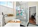 Elegant bathroom featuring a glass-enclosed shower, standalone tub, and hexagon tile, creating a spa-like experience at 225 Silverwood Ln, Summerville, SC 29485