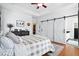 Stylish bedroom featuring a comfortable bed, hardwood floors, sliding doors, and ample natural light, creating a cozy atmosphere at 225 Silverwood Ln, Summerville, SC 29485