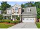 Charming two-story home with a covered porch, manicured landscaping, and a two-car garage at 225 Silverwood Ln, Summerville, SC 29485