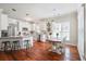 Charming kitchen with white cabinets, stainless steel appliances, hardwood floors, and a breakfast bar and dining table at 225 Silverwood Ln, Summerville, SC 29485