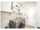 Well-organized laundry area with shelving, modern washer and dryer, and neutral color palette at 225 Silverwood Ln, Summerville, SC 29485