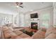 Cozy living room featuring a fireplace, a sectional sofa, and seamless access to the dining area at 225 Silverwood Ln, Summerville, SC 29485