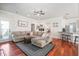 Comfortable living room with a sectional sofa, ceiling fan, and seamless access to the breakfast bar at 225 Silverwood Ln, Summerville, SC 29485
