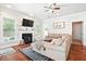 Cozy living room showcasing a fireplace, television, and a comfortable sectional sofa with hardwood floors at 225 Silverwood Ln, Summerville, SC 29485
