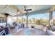 Spacious back porch with lake view, string lights, seating, and a table for relaxing and entertaining at 2312 Rushland Landing Rd, Johns Island, SC 29455
