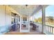 Inviting back porch features vintage decor, scenic views, and cozy furnishings for relaxation and entertaining at 2312 Rushland Landing Rd, Johns Island, SC 29455