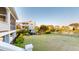 A scenic backyard with manicured lawn, a black iron fence, and views of the surrounding lake and homes at 2312 Rushland Landing Rd, Johns Island, SC 29455