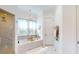 Bathroom featuring a marble tub, a glass shower and a view to a walk-in closet at 2312 Rushland Landing Rd, Johns Island, SC 29455