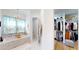 Bathroom with a bathtub, walk-in closet, heated towel rack and chandelier at 2312 Rushland Landing Rd, Johns Island, SC 29455