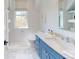 Bathroom featuring blue cabinets, a large mirror, white countertops, and natural light at 2312 Rushland Landing Rd, Johns Island, SC 29455