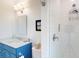 Bathroom features a sink with blue cabinetry, toilet and a sleek, tiled walk-in shower at 2312 Rushland Landing Rd, Johns Island, SC 29455