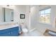 Bright bathroom featuring a sink with blue cabinetry, walk-in shower, and views of the water at 2312 Rushland Landing Rd, Johns Island, SC 29455