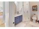 Stylish bathroom featuring a blue vanity, white subway tile shower, and elegant marble floors at 2312 Rushland Landing Rd, Johns Island, SC 29455