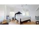 Well-lit bedroom showcasing a bed with a patterned quilt, white walls, and bright windows at 2312 Rushland Landing Rd, Johns Island, SC 29455